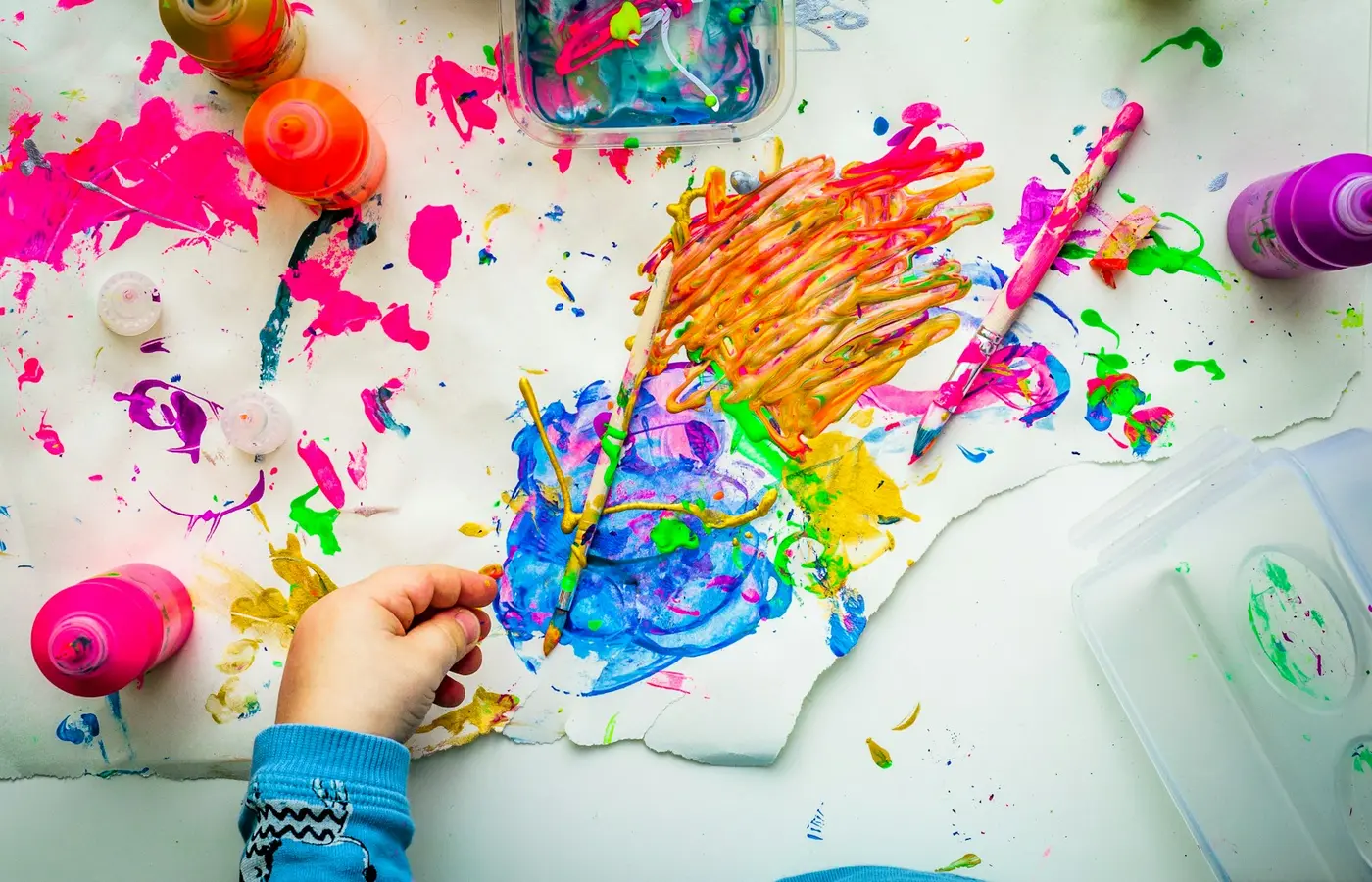 Young child’s art supplies arranged on a table