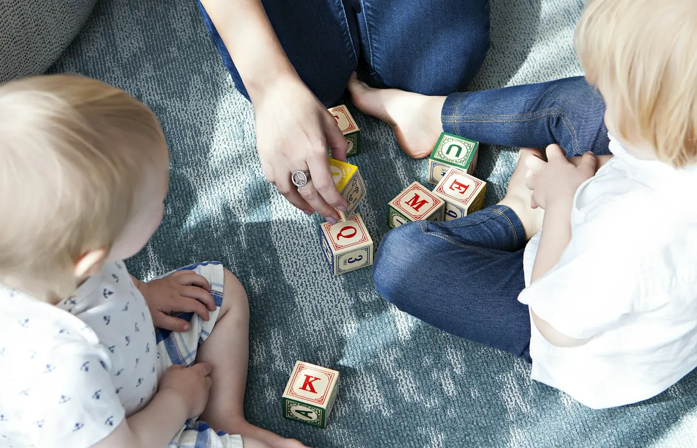 Toddlers playing with wooden blocks in a group