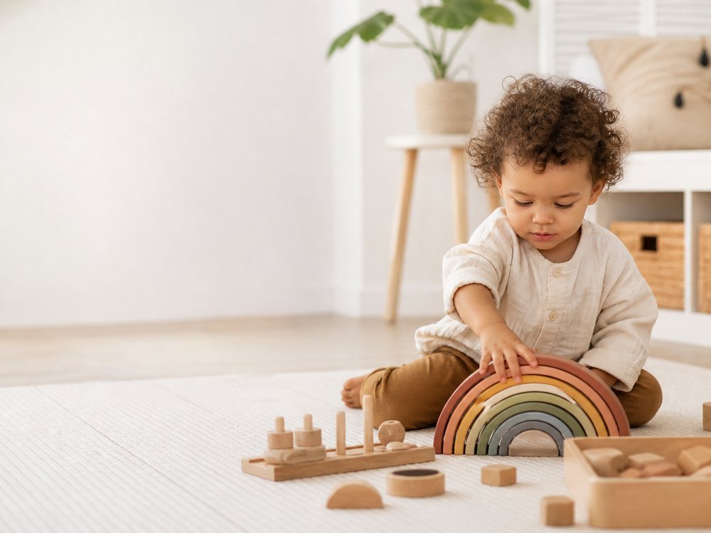 A toddler exploring open-ended wooden toys